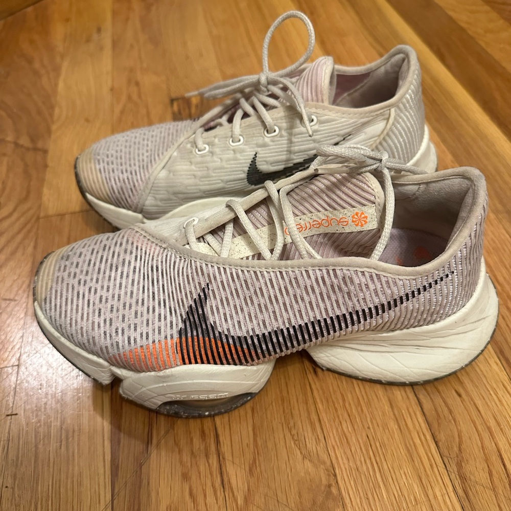 Nike Women's Light Pink and Black Running Sneakers with Orange Accent